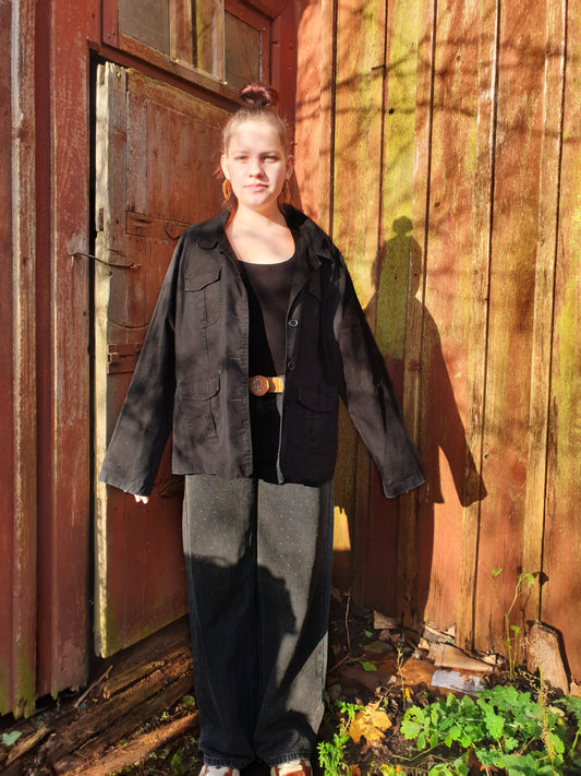 Front view of the relaxed-fit upcycled cotton jacket with four patch pockets and button closure.