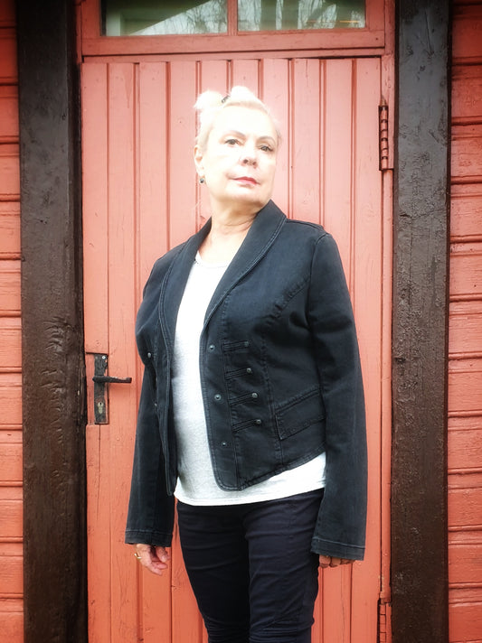 Hand-painted upcycled black denim jacket, front view – military-style cut with snap buttons.