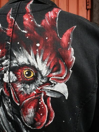 Close-up detail of the painted rooster on the upcycled denim jacket.
