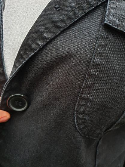 Close-up of the front pocket and stitching on the hand-painted cotton jacket.