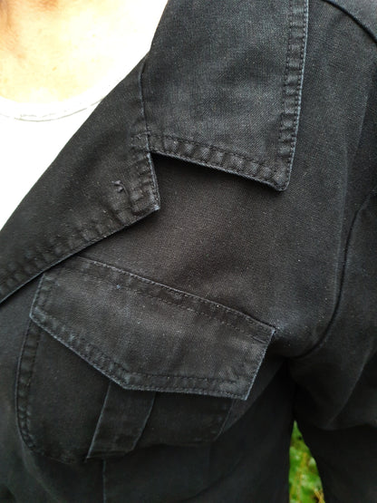 Close-up of the front pocket and stitching on the hand-painted cotton jacket.