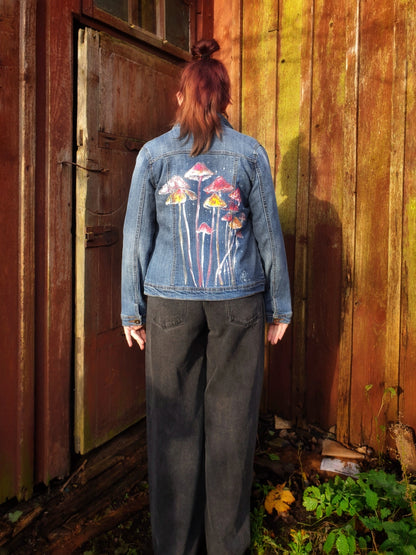 Model wearing the “Jumpy Magic Mushrooms” hand-painted denim jacket by Hele Artwear.