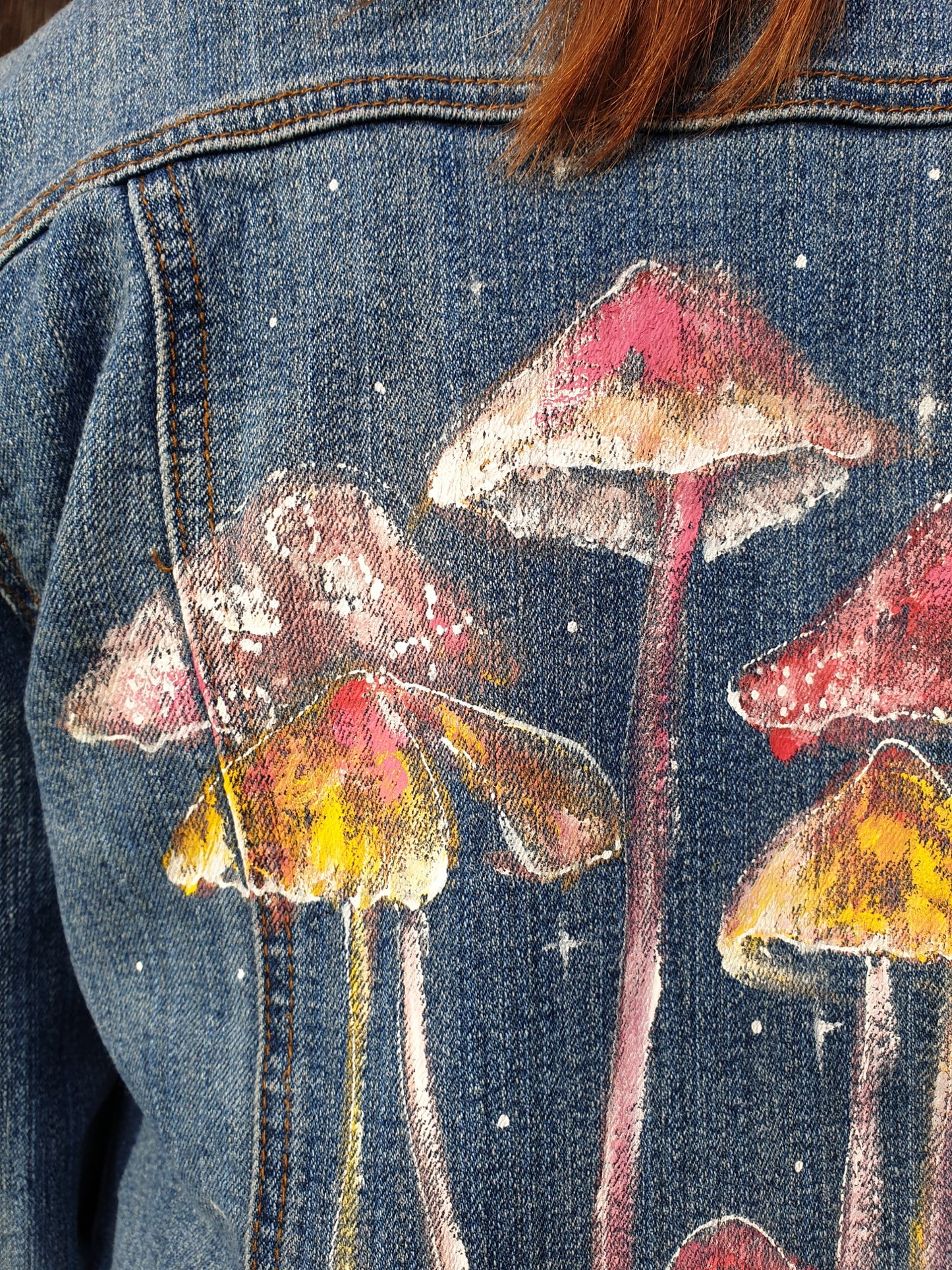Denim jacket with hand-painted mushrooms design Close-up detail of hand-painted mushrooms on the sustainable upcycled denim jacket.