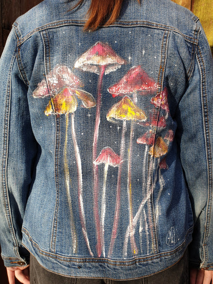 Back view showing colorful mushroom artwork on the “Jumpy Magic Mushrooms” denim jacket.