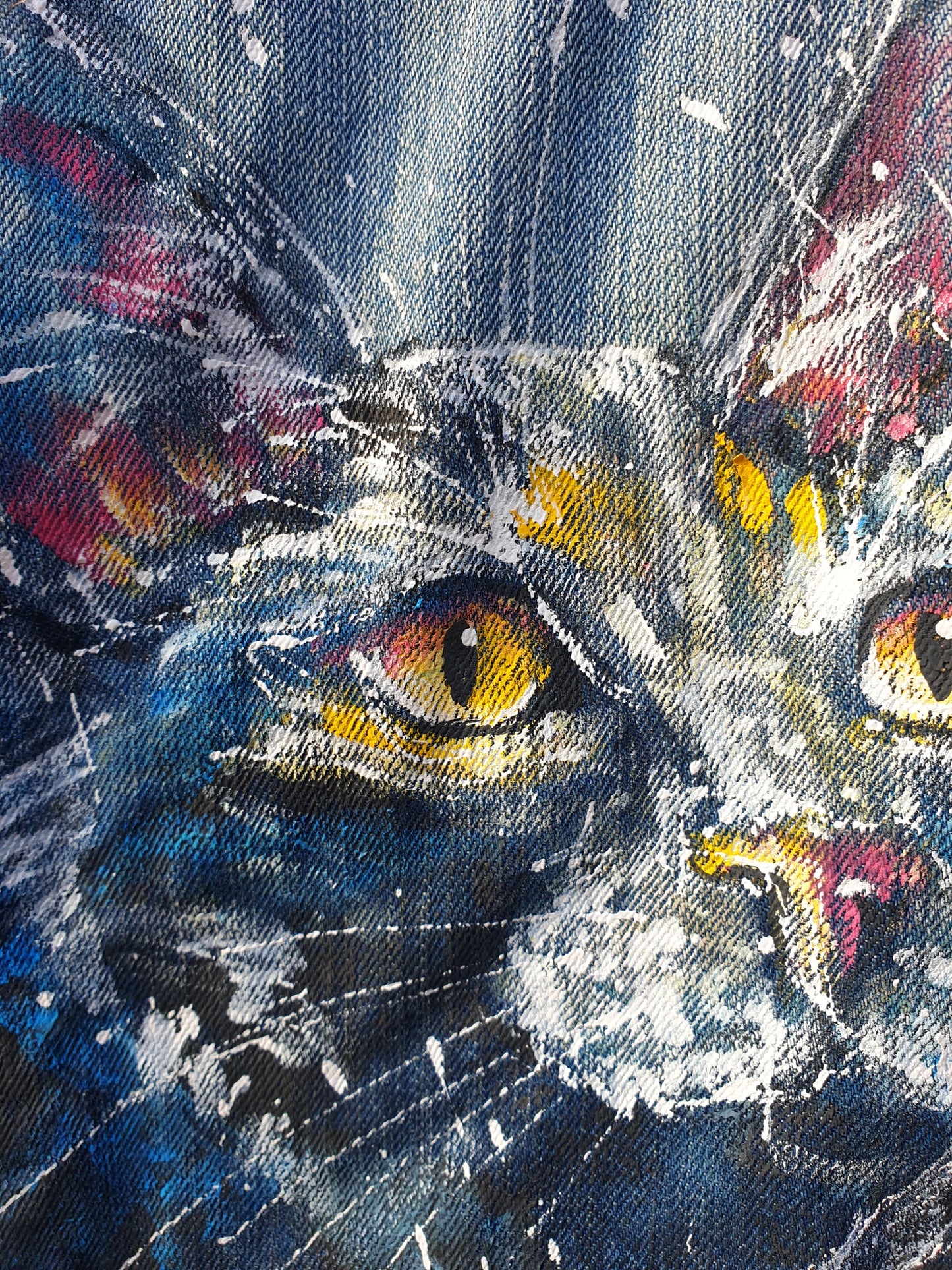 Close-up of the painted cat artwork showing white splashes and expressive brushstrokes.
