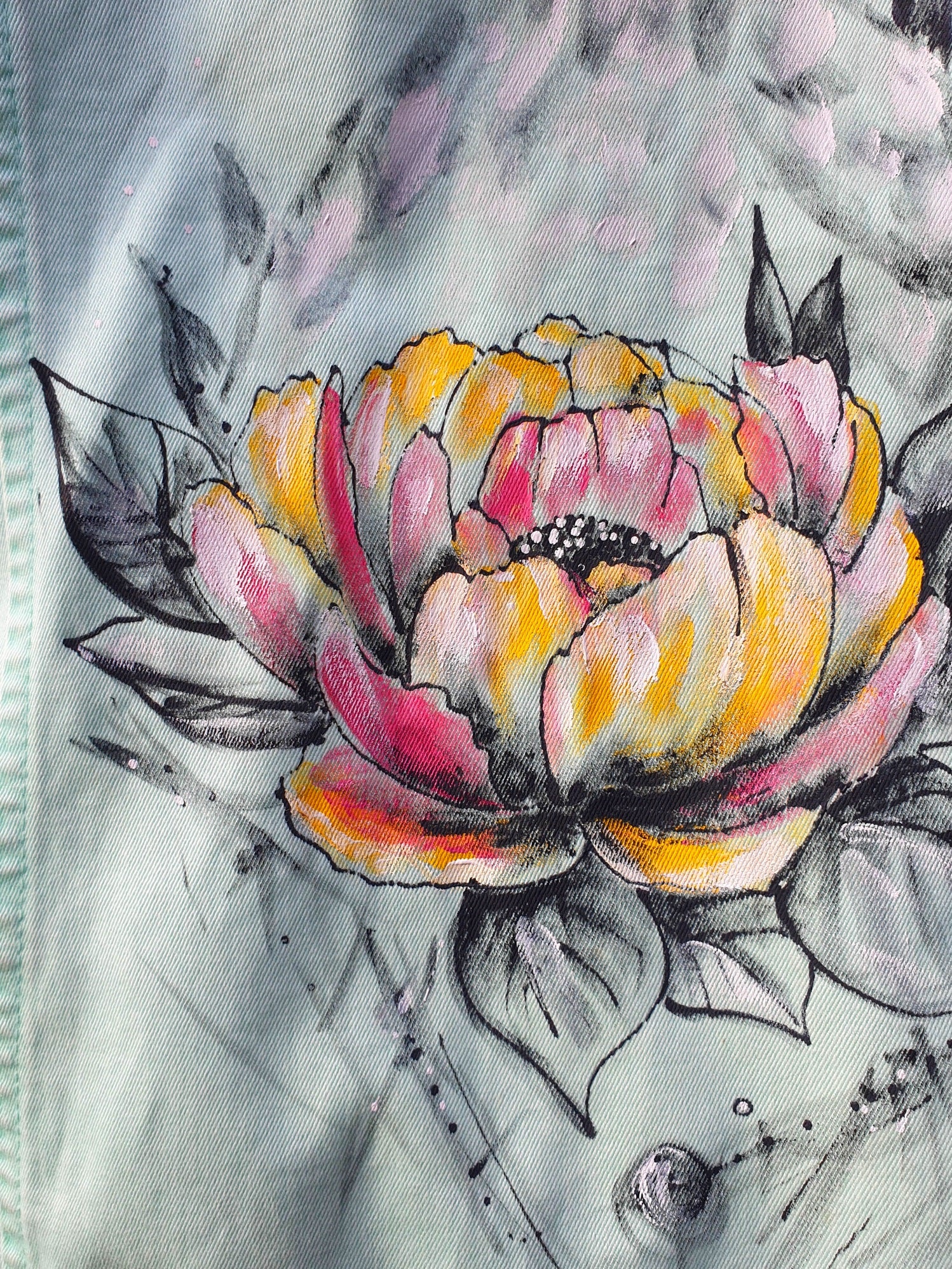 Close-up of the flower detail painted in pink, orange, and yellow tones on the back.2