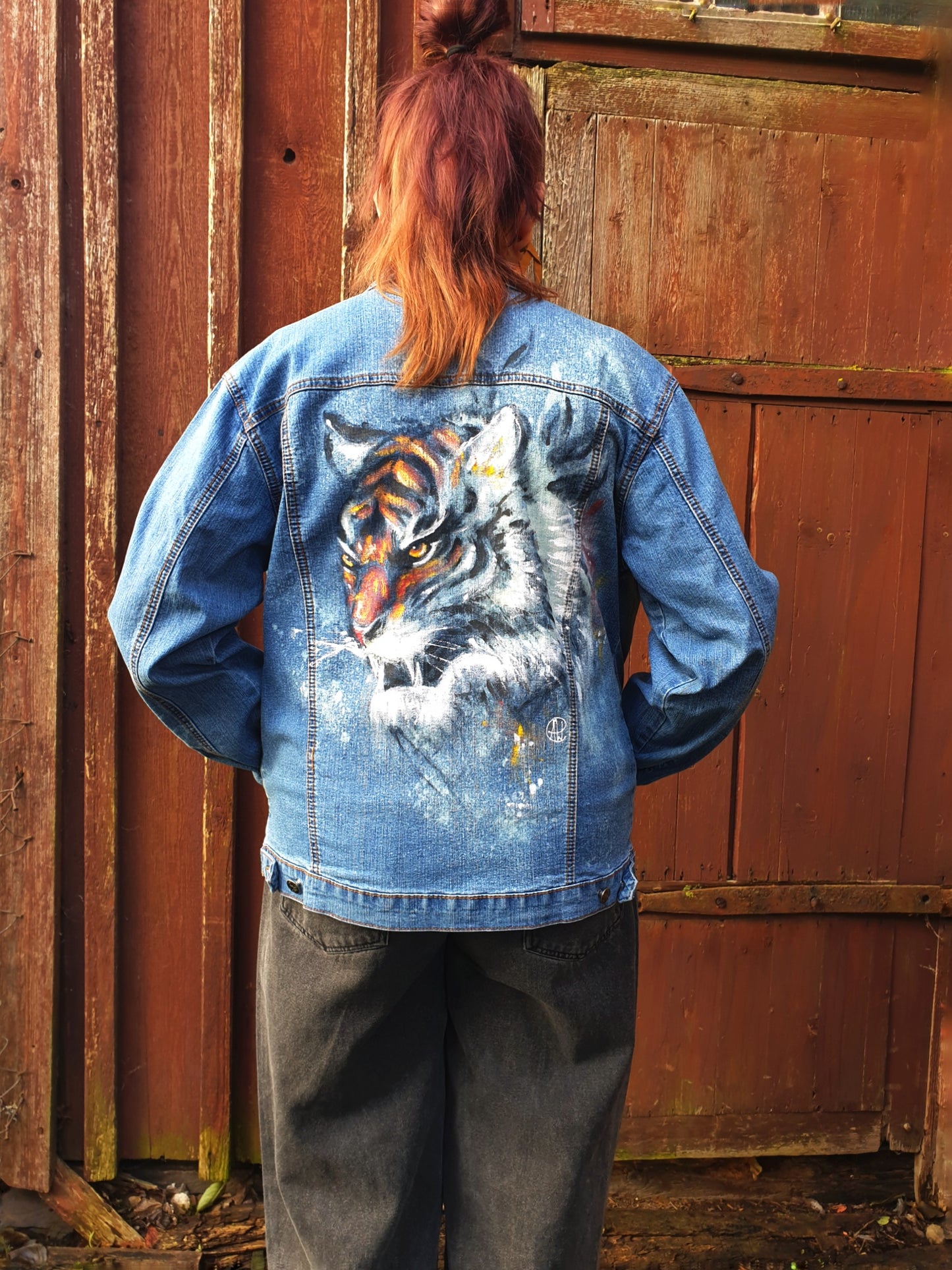 Back view of the “Reverse Tiger Logic” redesigned denim jacket featuring a hand-painted tiger created with color and bleach.