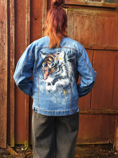 Back view of the “Reverse Tiger Logic” redesigned denim jacket featuring a hand-painted tiger created with color and bleach.