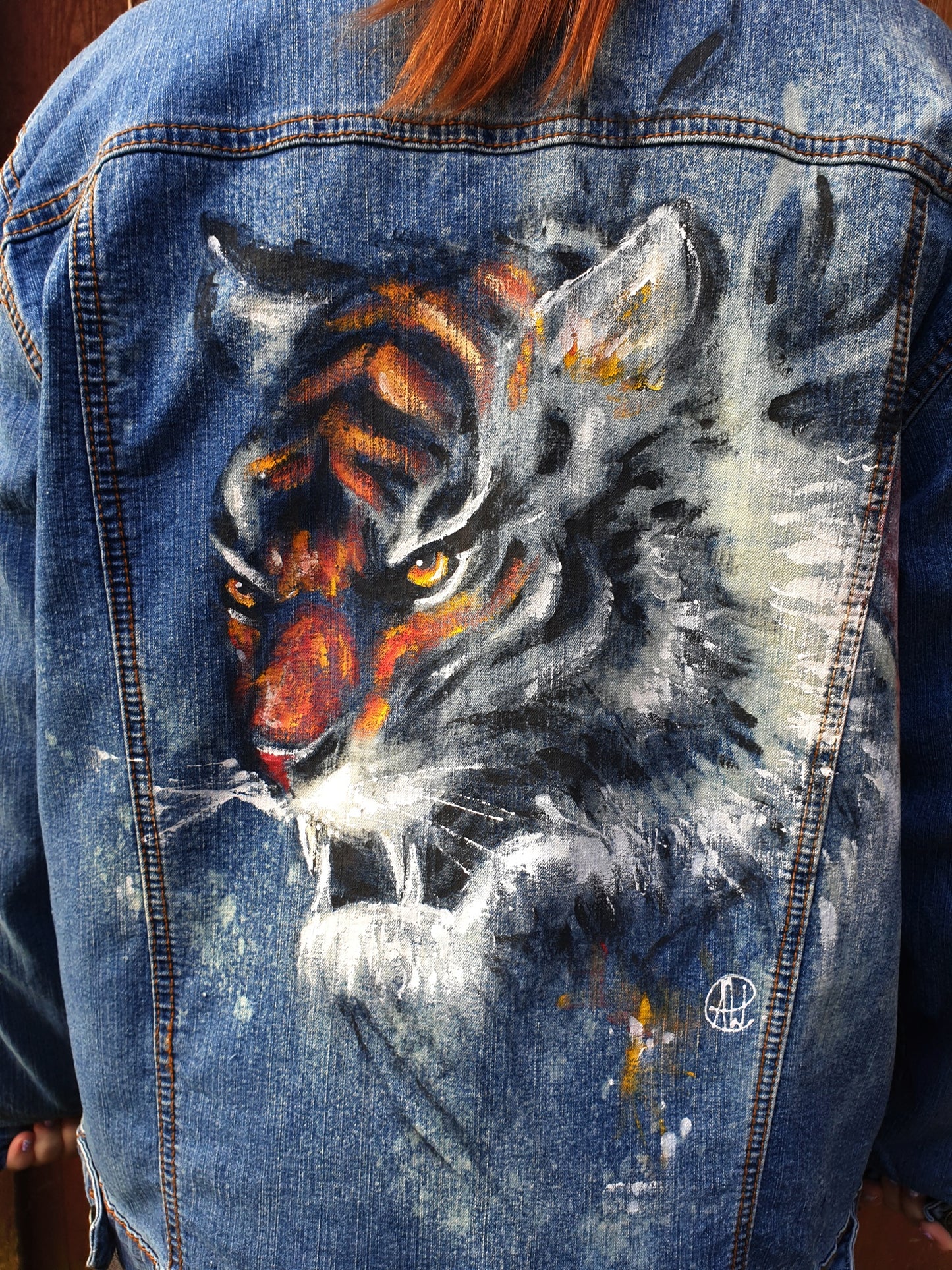 Close-up of the tiger artwork showing vivid color and bleach contrast on denim.