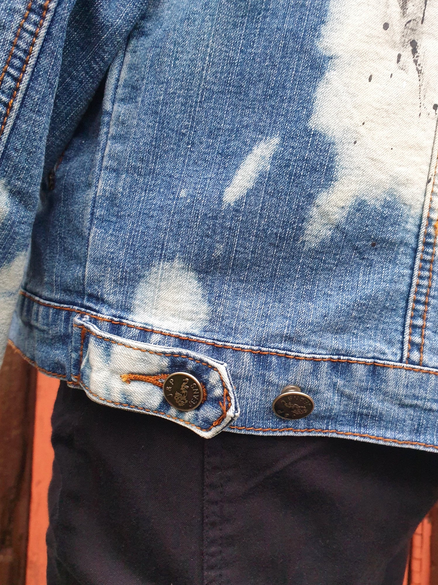 Detail of stitching on the upcycled denim jacket.