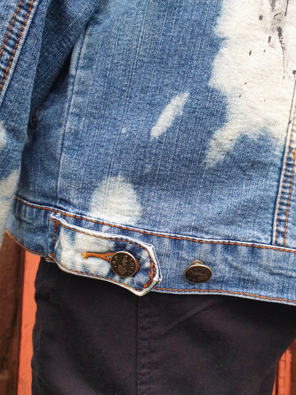 Detail of stitching on the upcycled denim jacket.