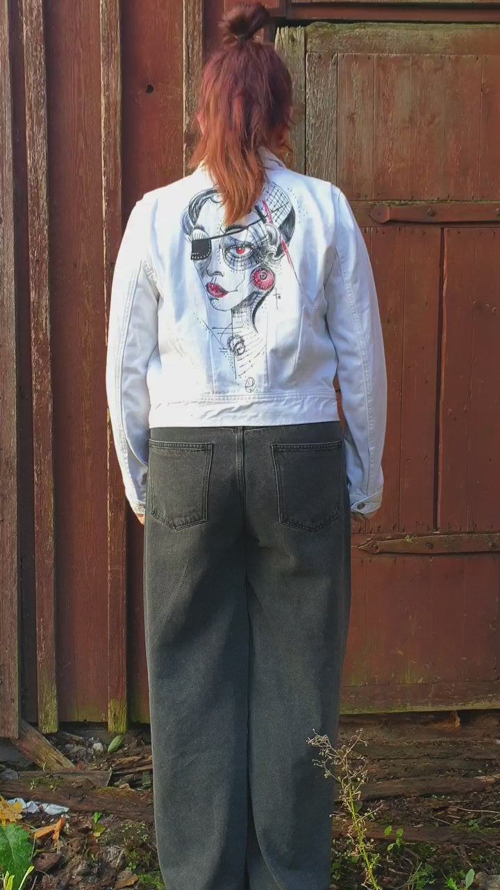 Close-up of the painted portrait in red and black tones with geometric details. Model view