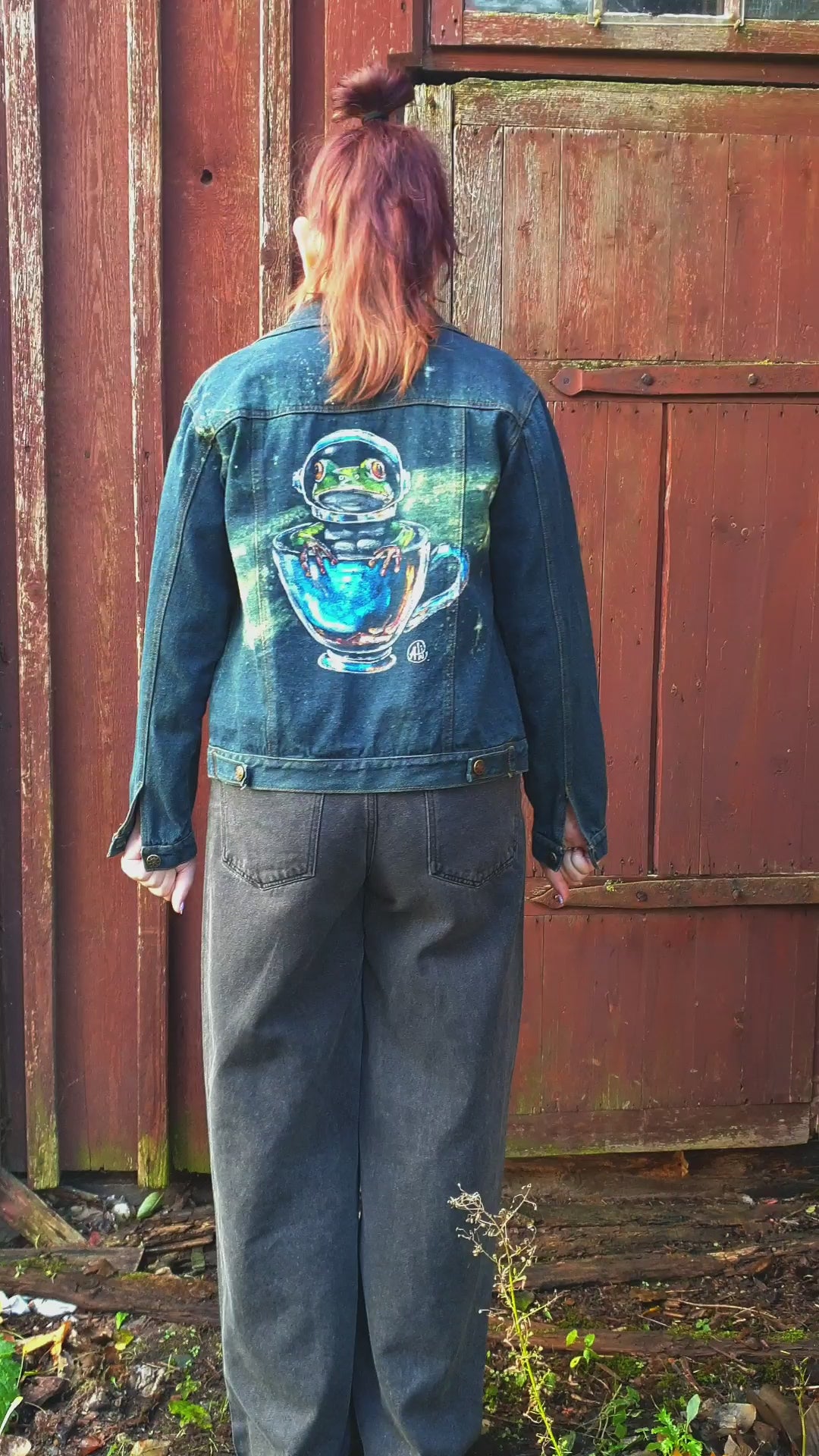 Model wearing the Space Frog Commander hand-painted upcycled denim jacket by Hele Artwear.