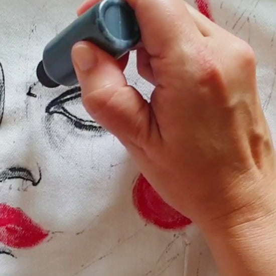 Close-up of the painted portrait in red and black tones with geometric details. Painting