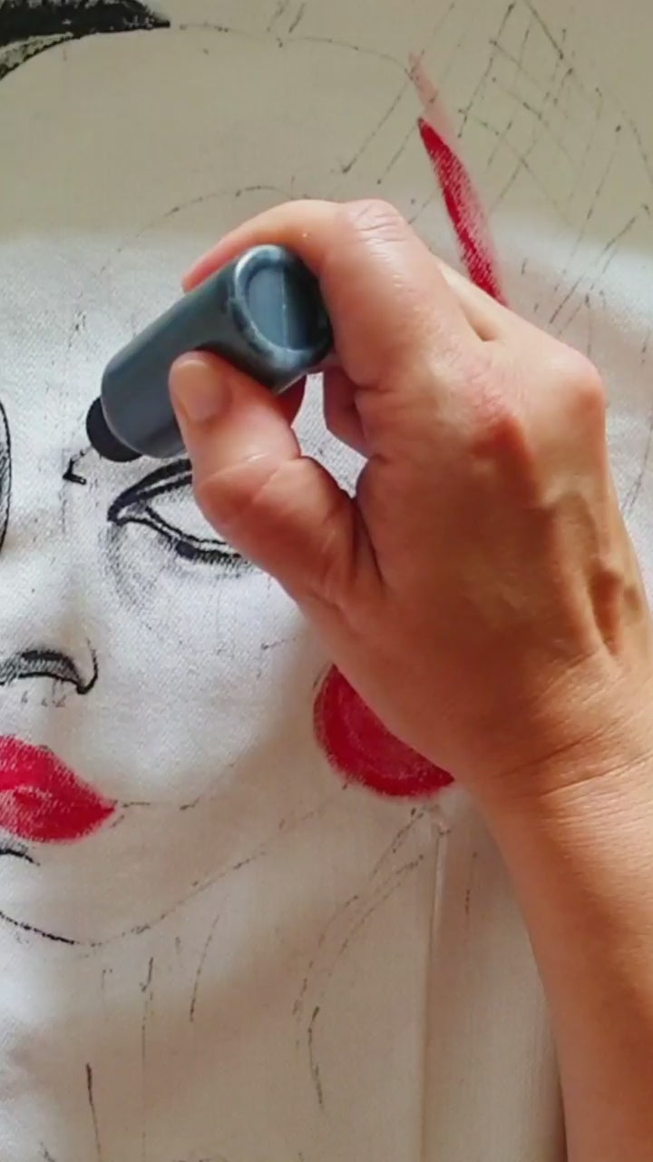 Close-up of the painted portrait in red and black tones with geometric details. Painting