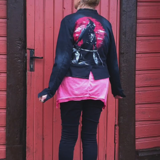 Model view of the “Sunset Samurai” hand-painted deep navy denim jacket showing a samurai silhouette against a red sunset.