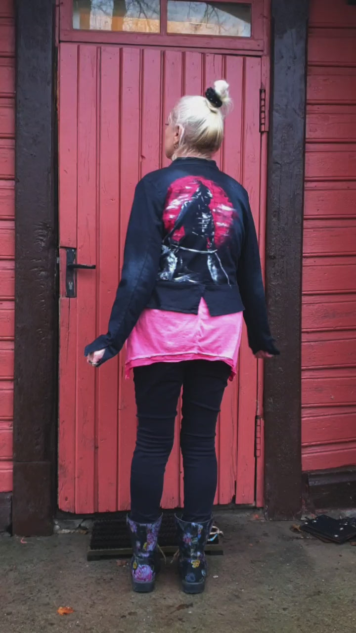Model view of the “Sunset Samurai” hand-painted deep navy denim jacket showing a samurai silhouette against a red sunset.