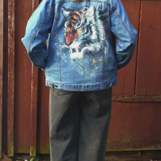 Close-up of the tiger artwork showing vivid color and bleach contrast on denim. model view